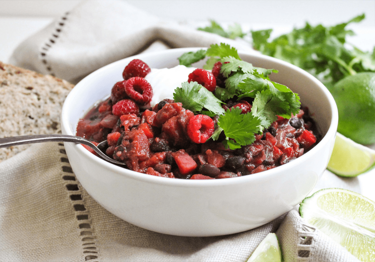 raspberry chili in a white bowl topped with cilantro