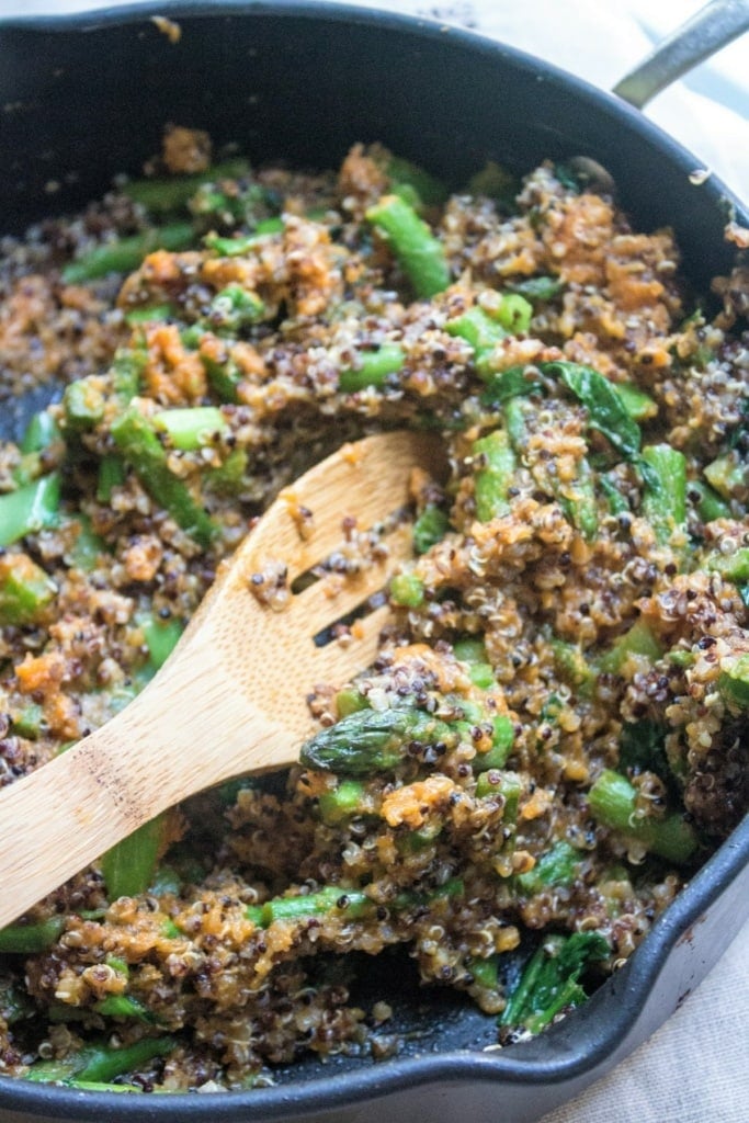 pumpkin quinoa in a skillet with a wooden spoon