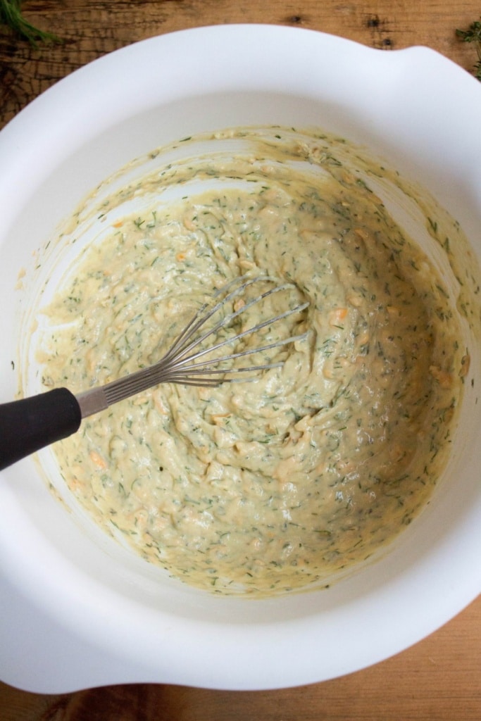 savory muffin batter in a bowl with a whisk