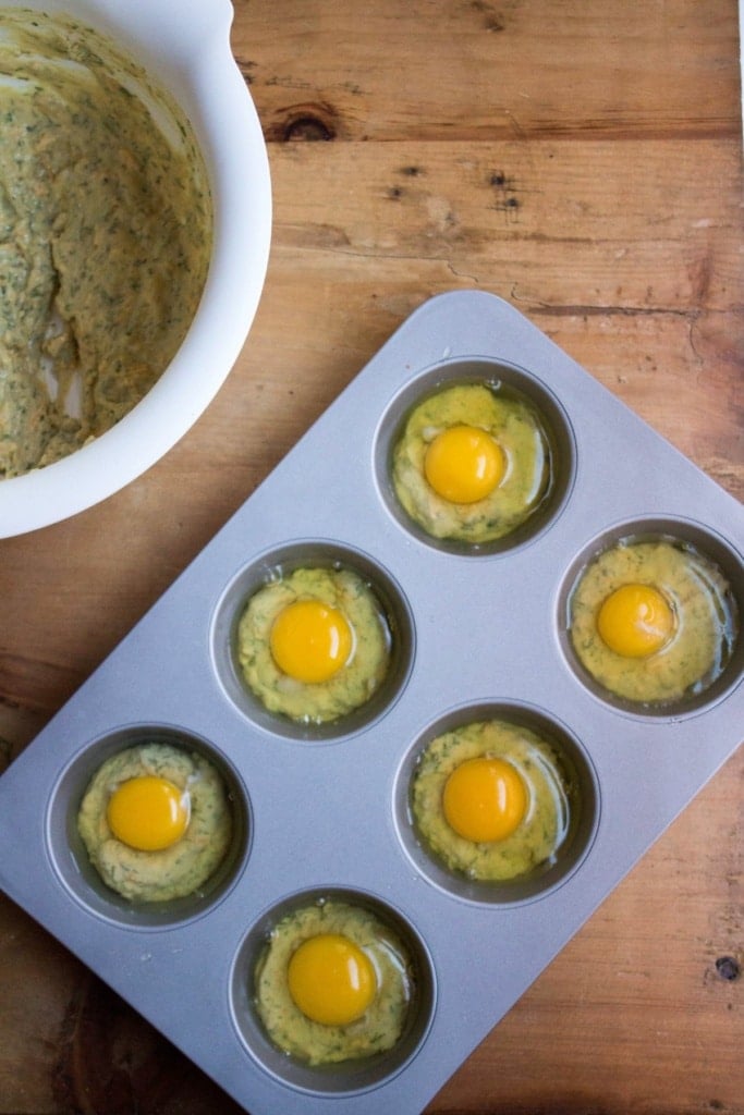 eggs cracked into a muffin tin
