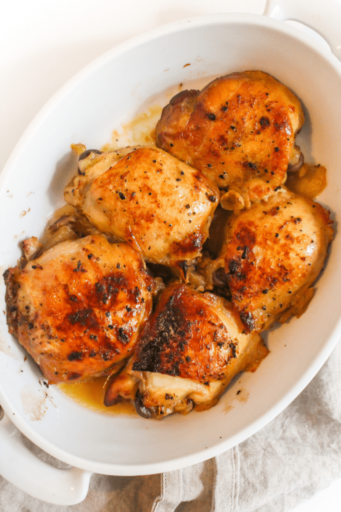 roasted chicken thighs in a white dish