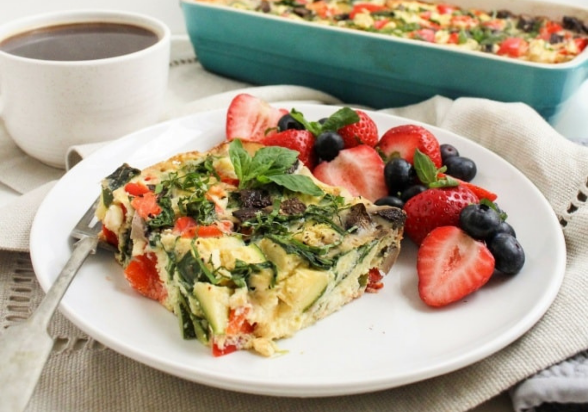 slice of smoked salmon breakfast casserole with berries on the side