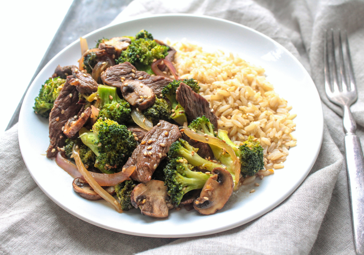 beef and broccoli stir fry with rice on a plate