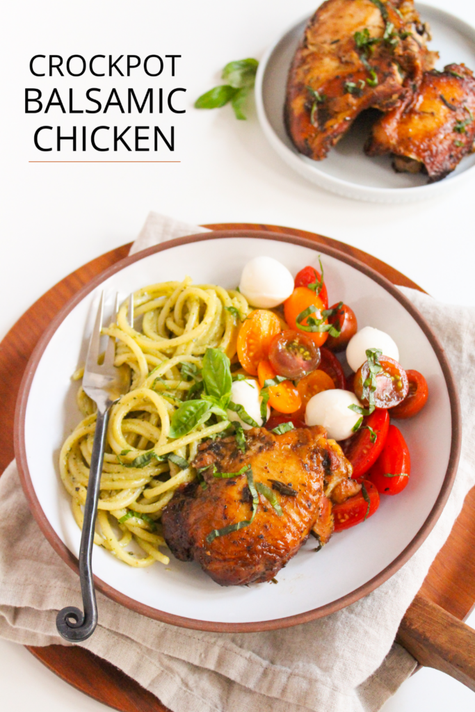 crockpot balsamic chicken on a plate with pesto pasta and caprese salad
