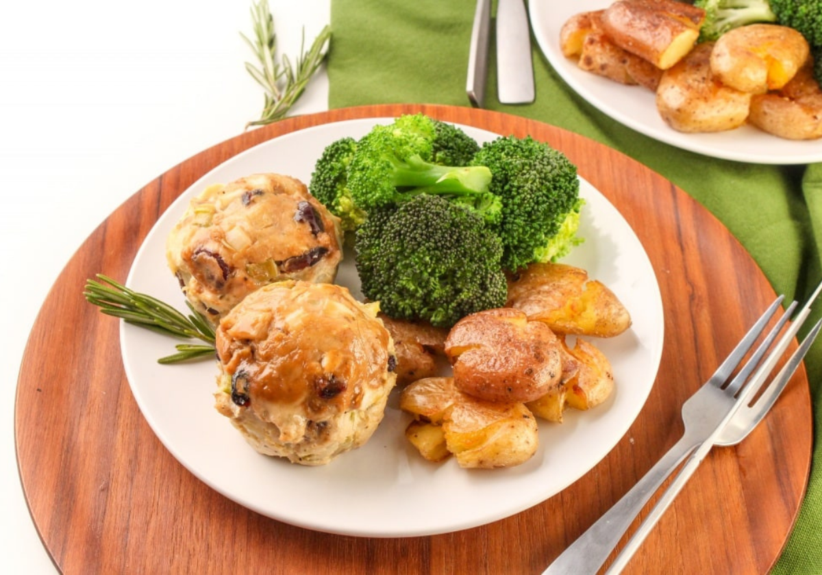 ground turkey meatloaf muffins on a plate with broccoli and potatoes