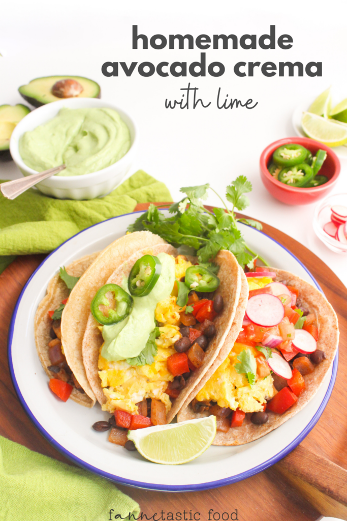 avocado lime crema in a bowl with a plate of breakfast tacos