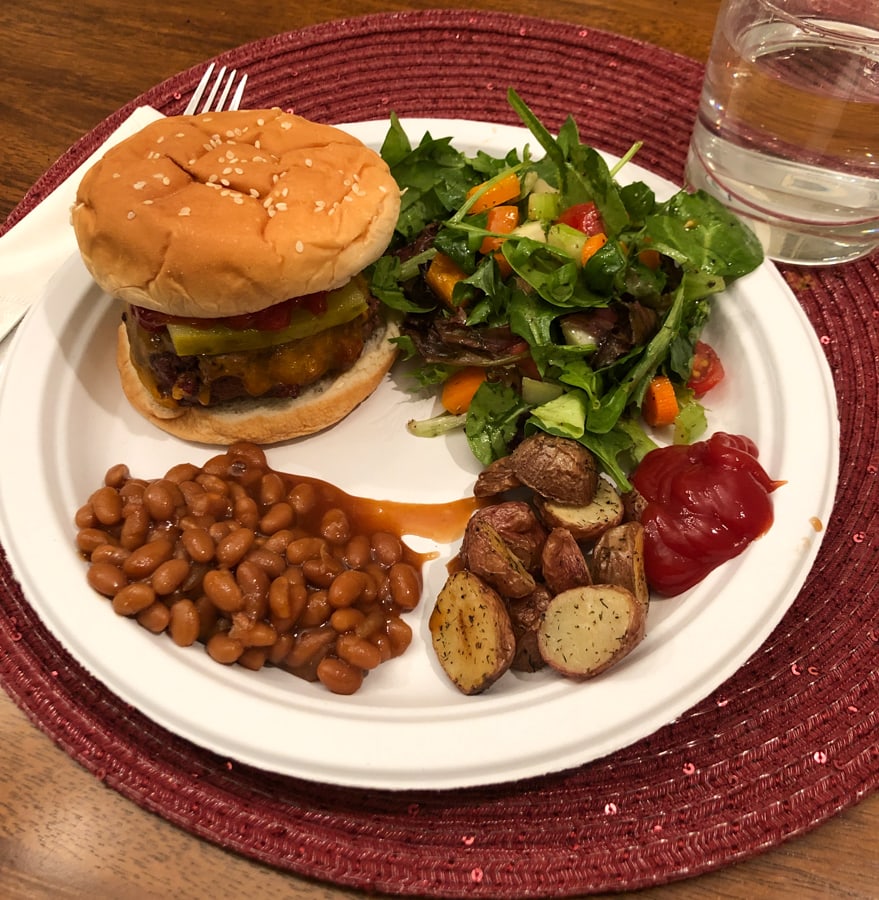 burger baked beans, roasted potatoes, and salad