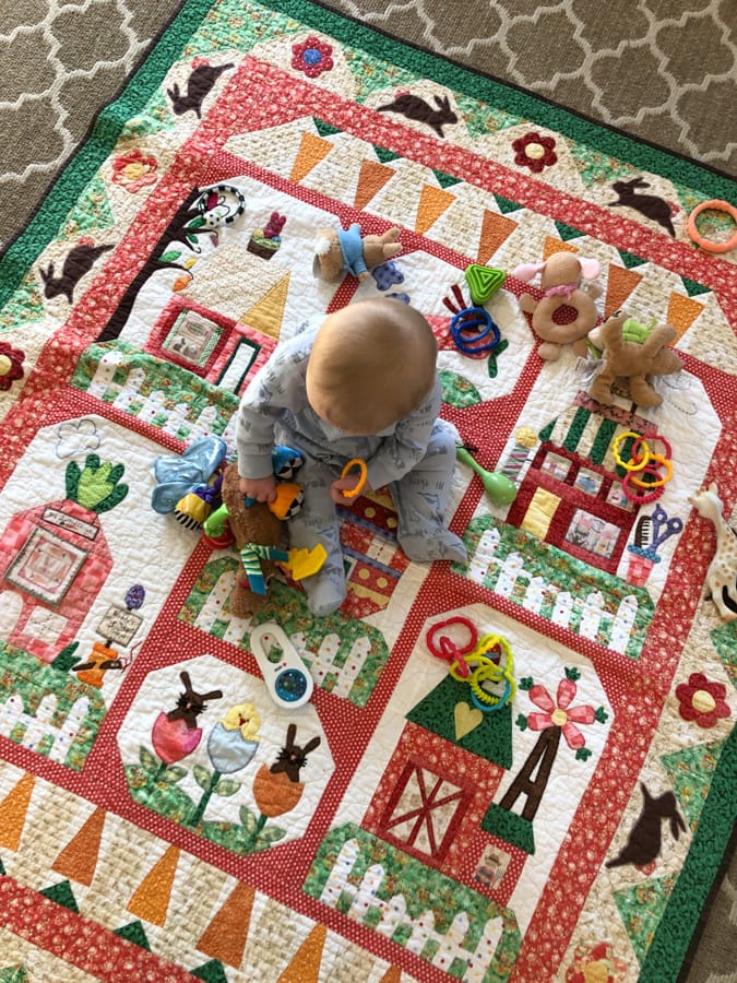 7 month old baby on play blanket