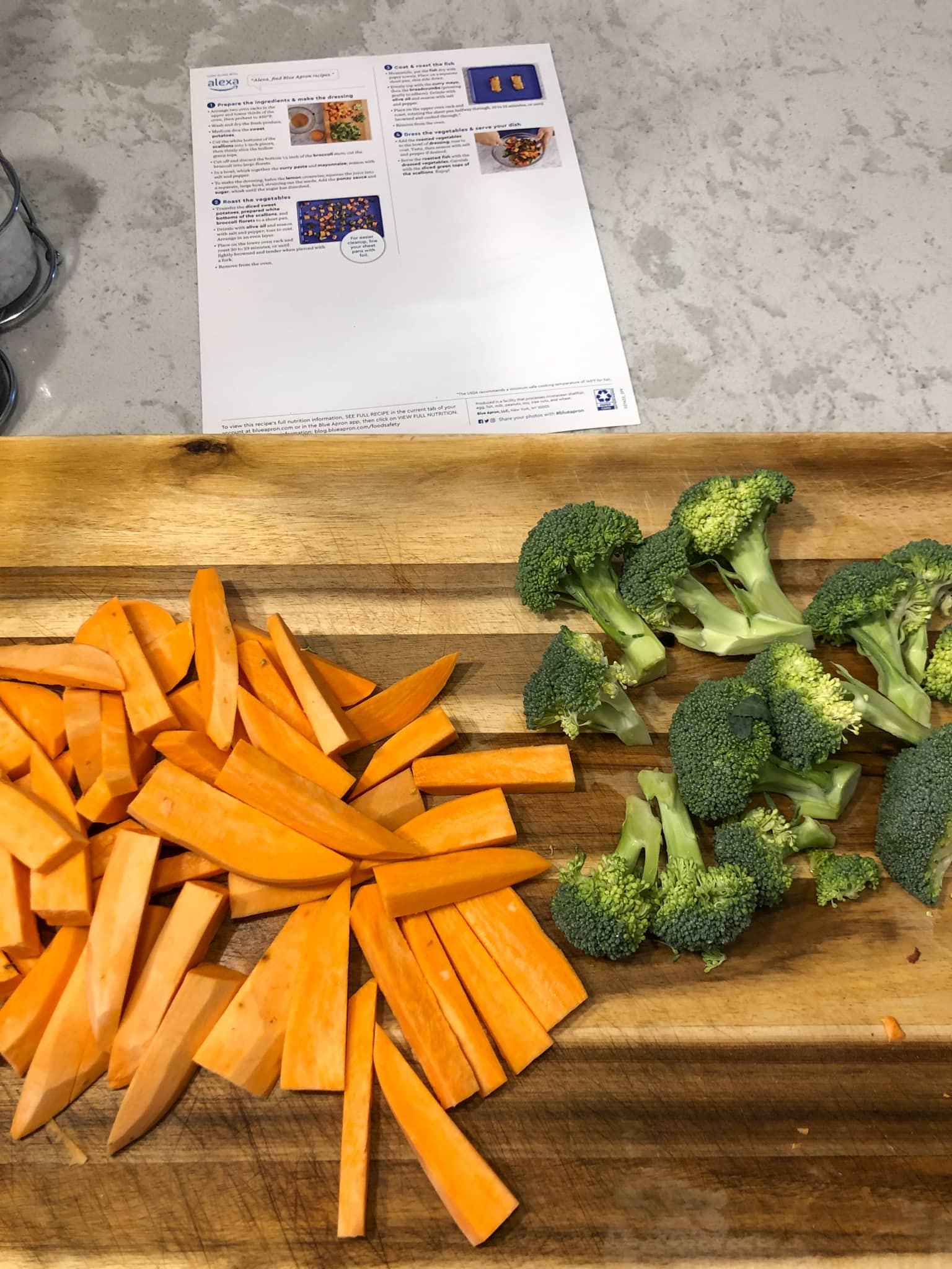prepping blue apron dinner sliced sweet potatoes and broccoli