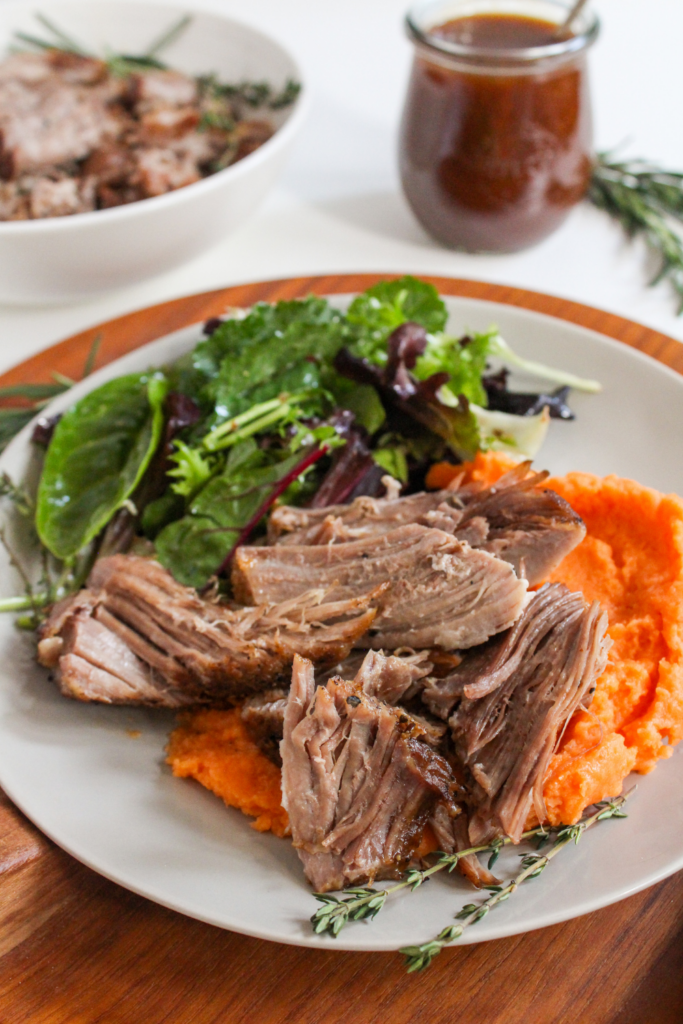 roast pork with mashed sweet potatoes and a green salad