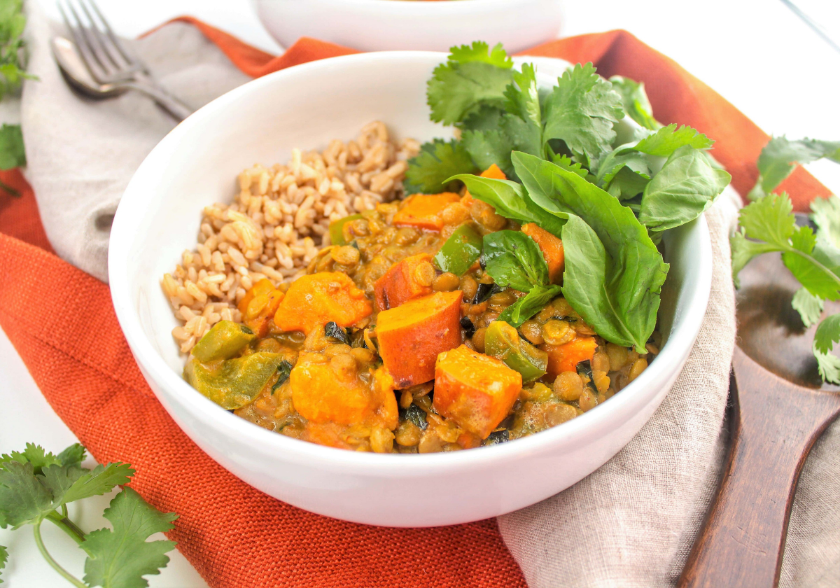sweet potato lentil curry in a white bowl with thai bail