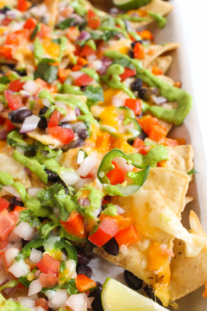 sheet pan vegetarian nachos with avocado crema