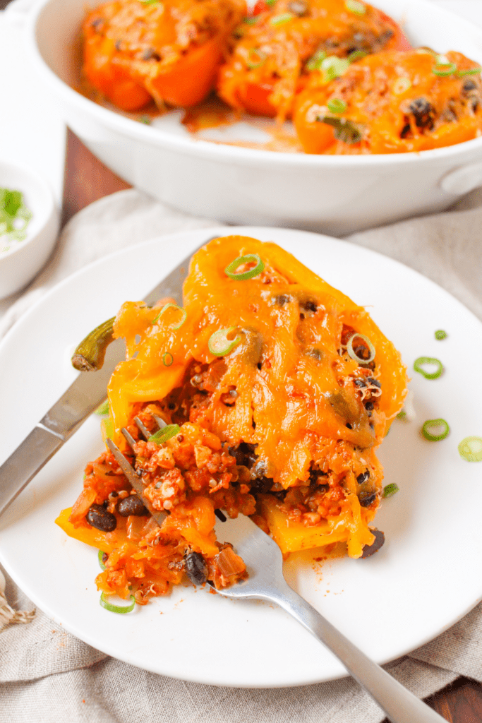 Mexican stuffed pepper on a white plate with a fork