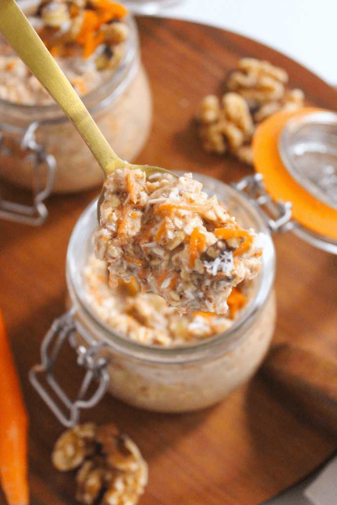 carrot cake overnight oats in a jar with a gold spoon