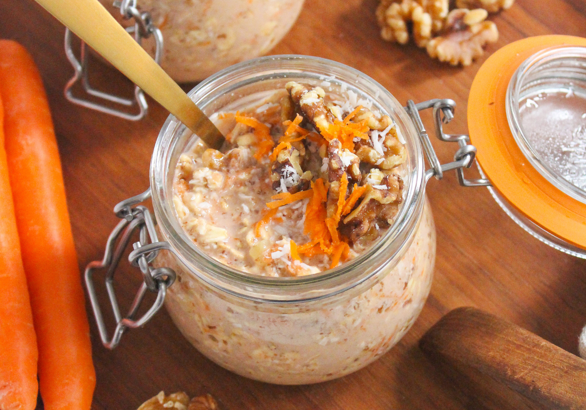 meal prep carrot cake overnight oats in a jar with a golden spoon