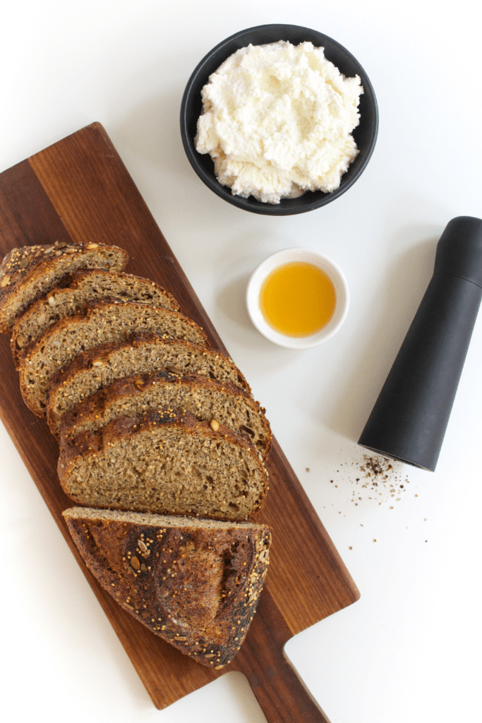 cheese with seedy bread and a pepper shaker