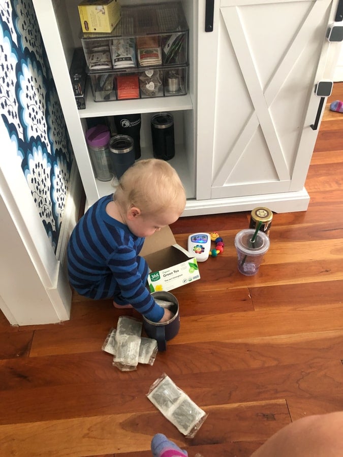 toddler playing with tea bags