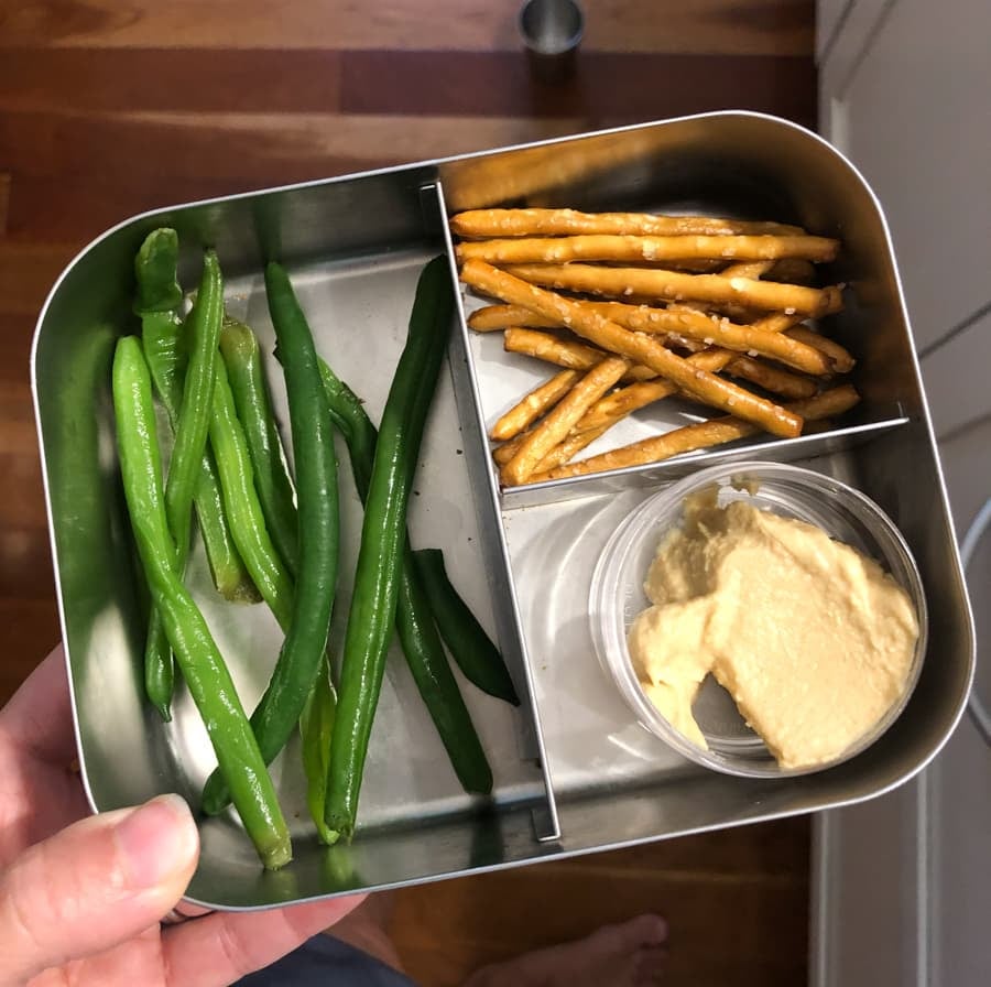 snack box with hummus, pretzels and string beans