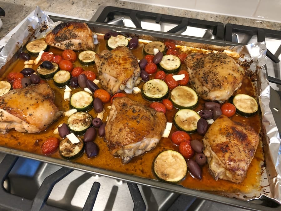 baked chicken thighs with zucchini, cherry tomatoes, olives, and feta