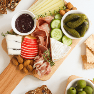 small charcuterie board with pickles and apple slices