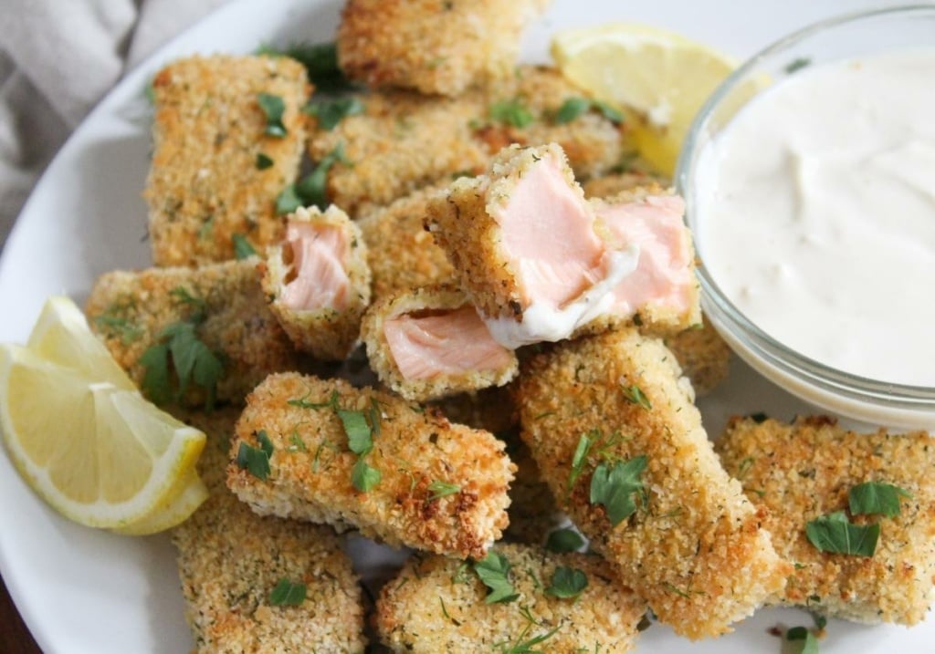 baked salmon bites with dipping sauce on a plate