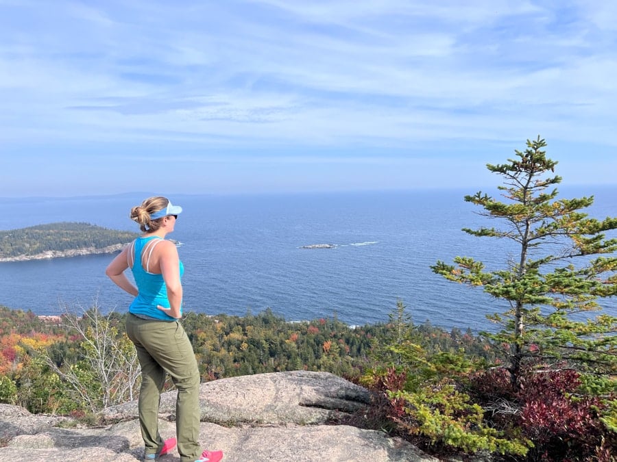 anne mauney looking at the view of the ocean in acadia national park