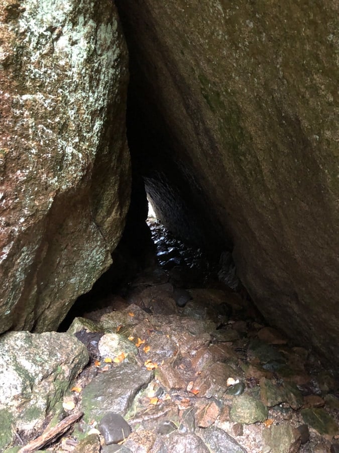 hiking through a cave in acadia