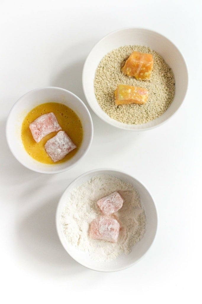 salmon cubes in bowls of flour, panko breadcrumbs, and egg