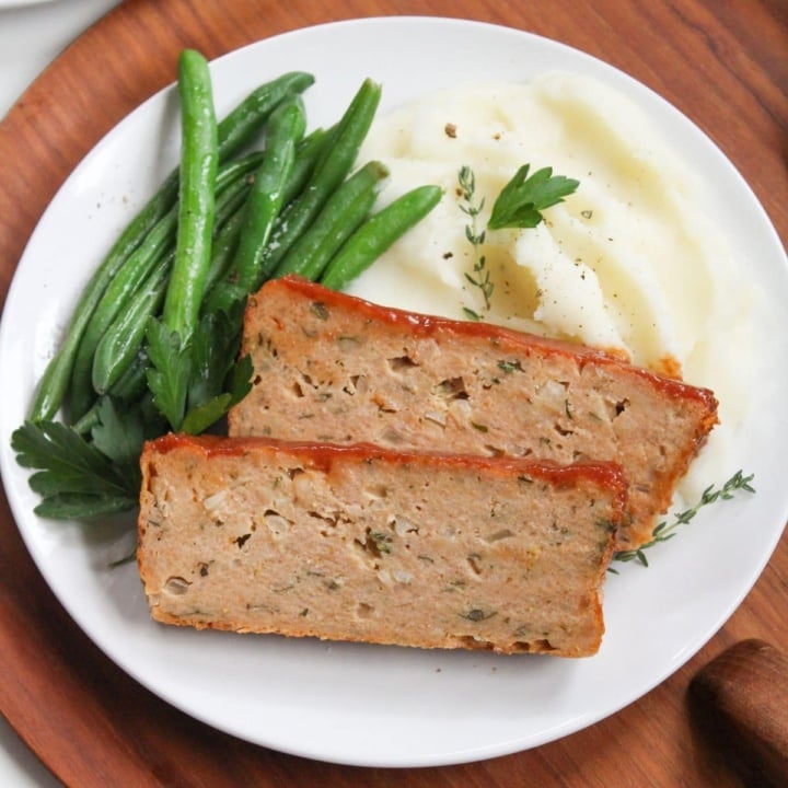 glazed ground chicken meatloaf with green beans on a plate