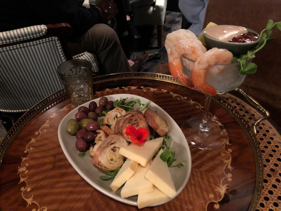 shrimp cocktail and a cheese and olive snack plate