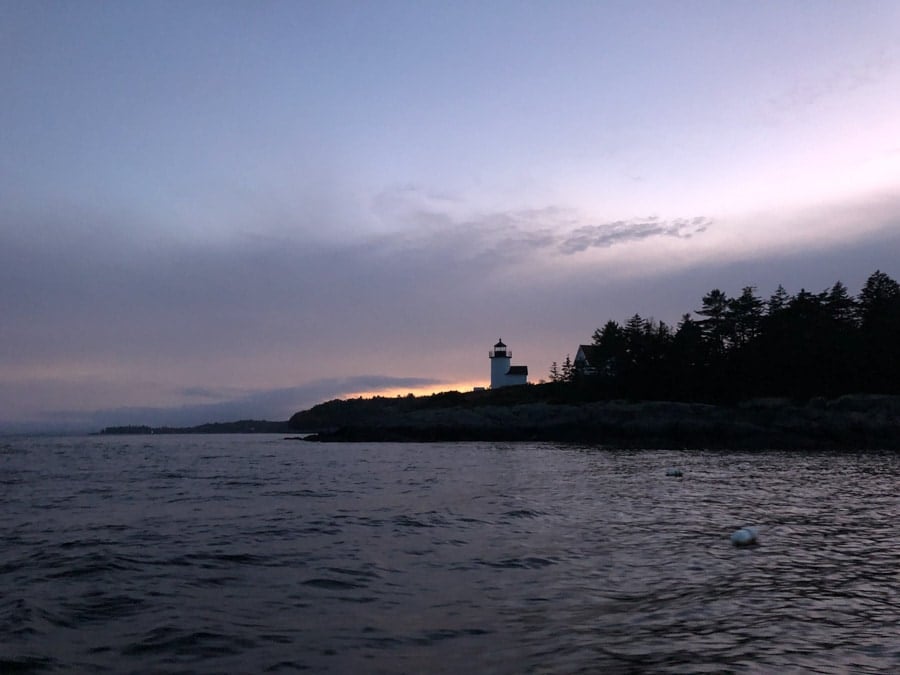 camden maine lighthouse at sunset view from the water