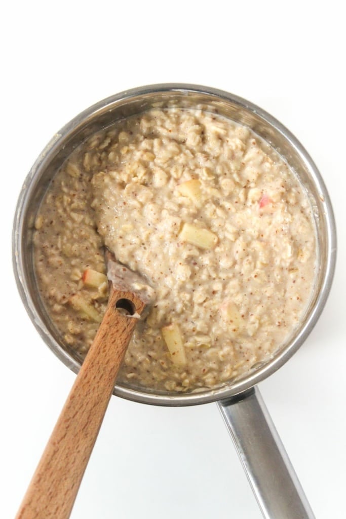 oatmeal in a saucepan with a wooden spoon