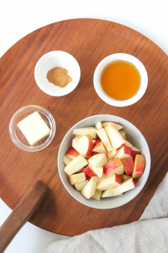 diced apples, honey, cinnamon, and butter on a wooden platter