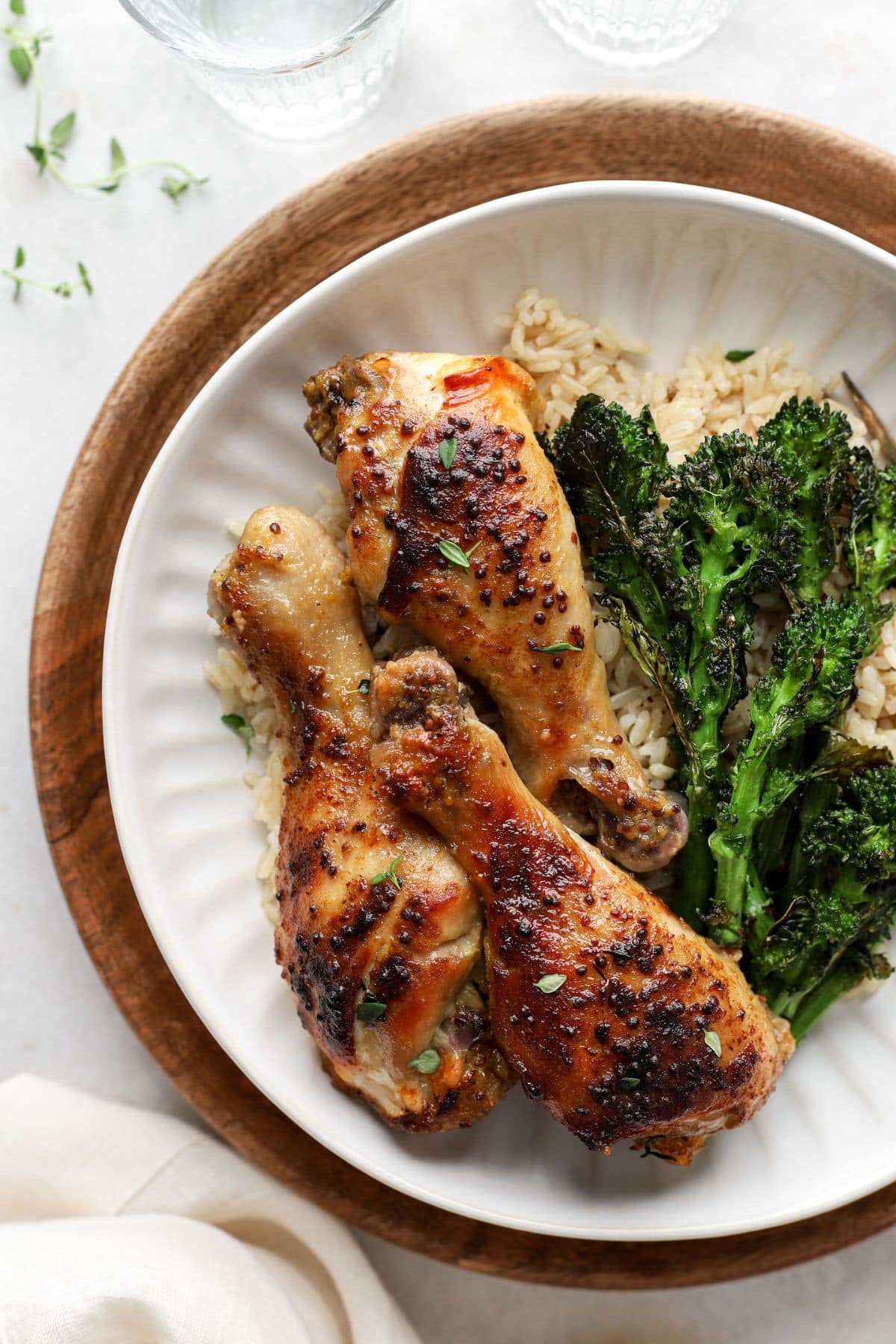 honey mustard chicken drumsticks on a plate with broccolini