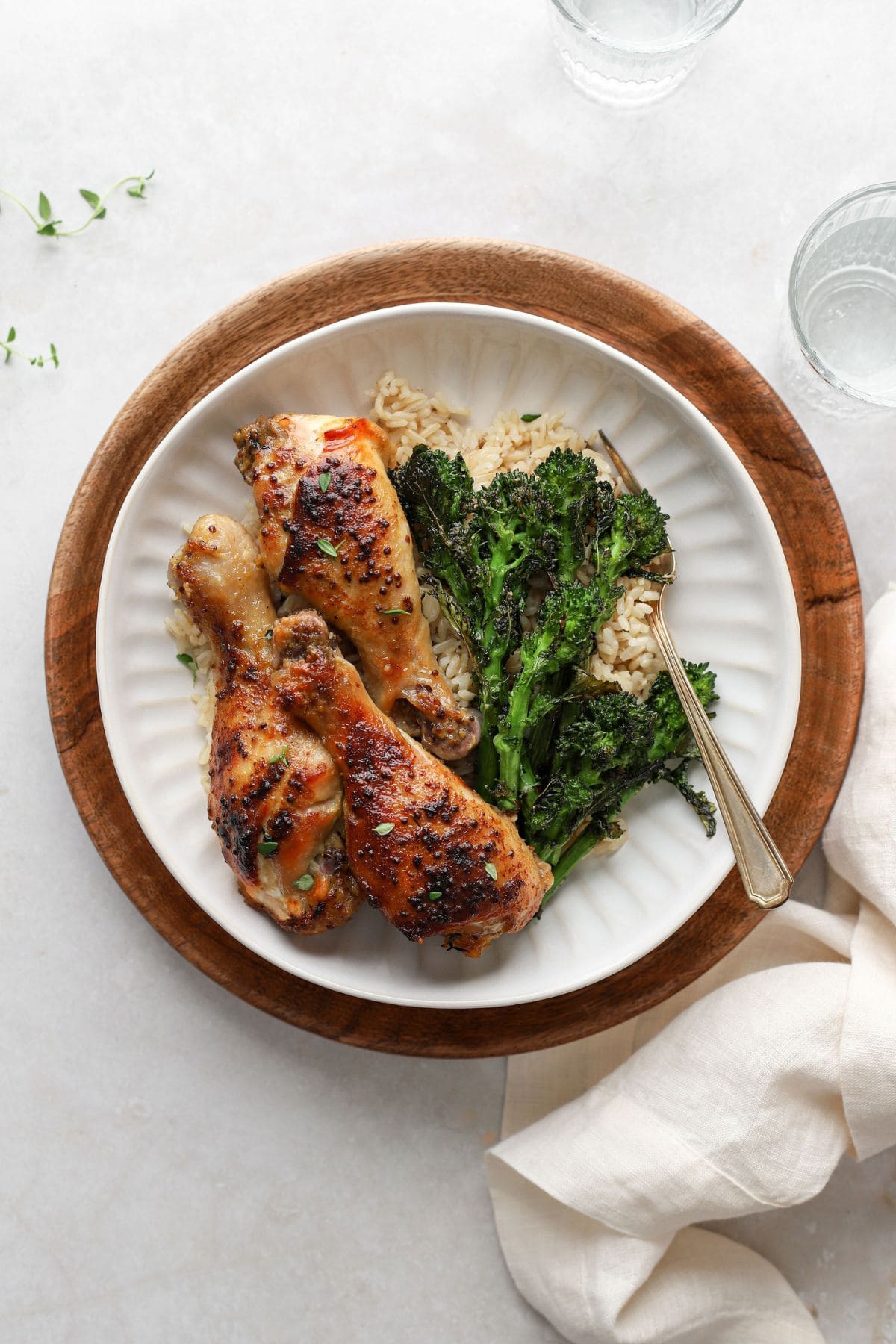 roasted chicken drumsticks with honey mustard sauce on a plate with broccolini