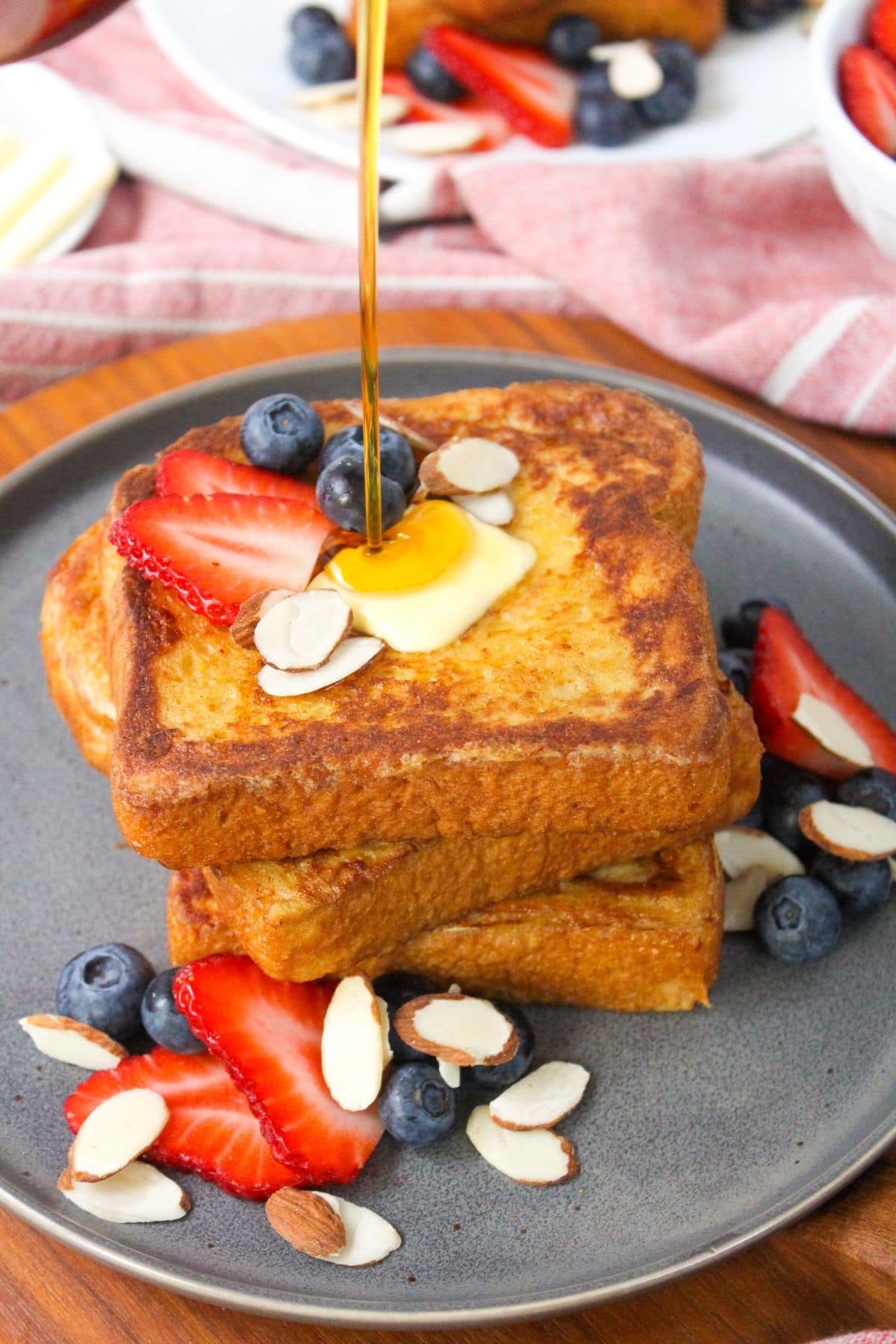 stack of french toast with maple syrup drizzled on top