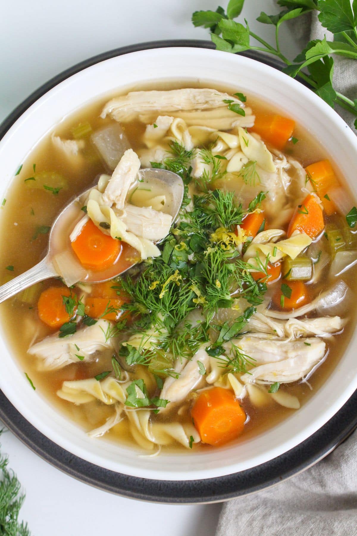 slow cooker chicken noodle soup with vegetables in a bowl