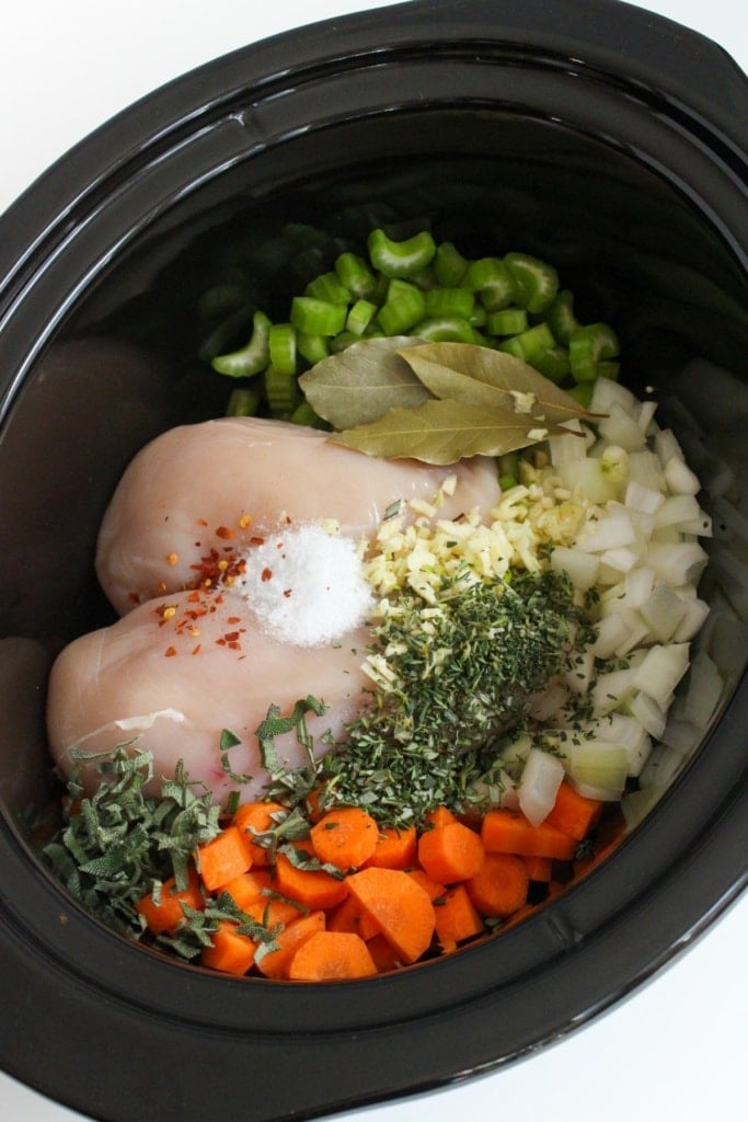 chicken breasts and vegetables in a slow cooker insert