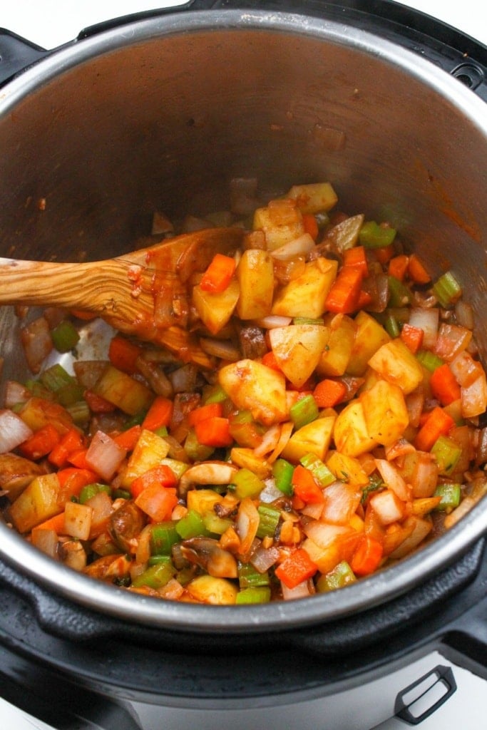 vegetables and tomato paste in a pressure cooker