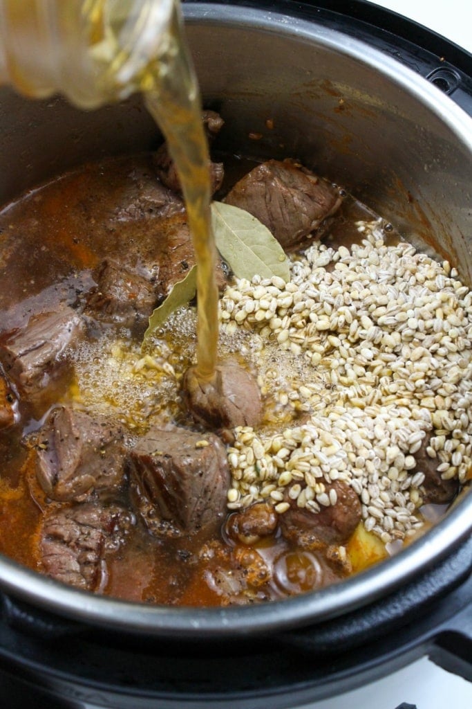 beef broth and barley in a pressure cooker