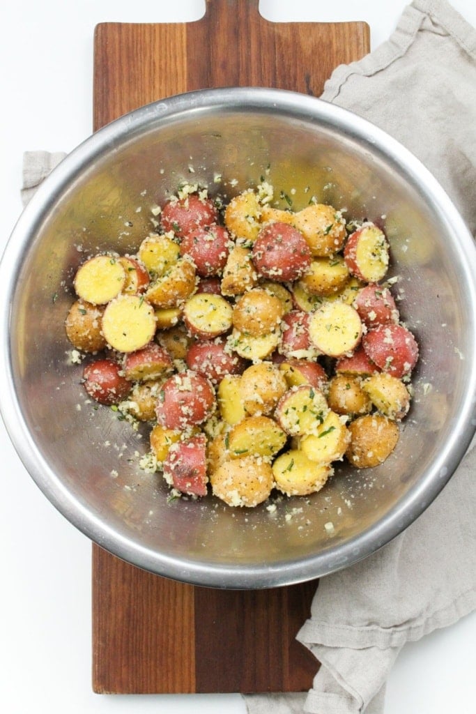 mini potatoes in a bowl with garlic and parmesan