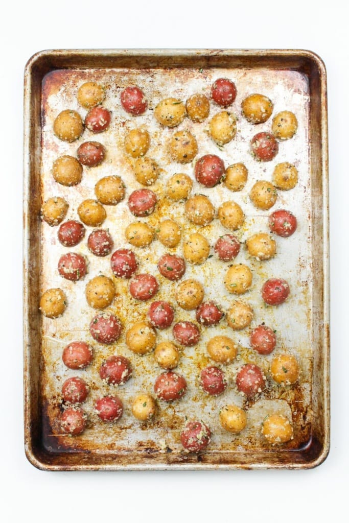 roasted garlic parmesan mini potatoes on a sheet pan