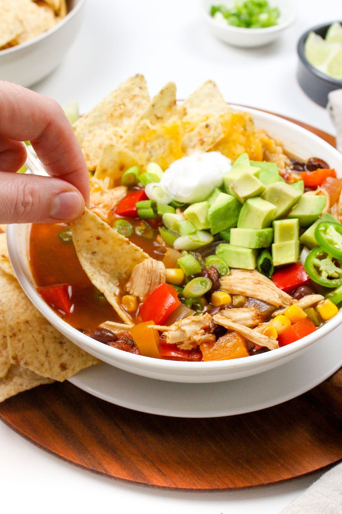 slow cooker chicken taco soup in a bowl with tortilla chips