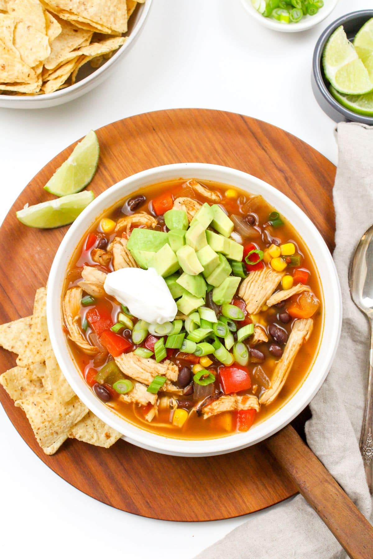 bowl of Mexican soup with avocado and tortilla chips