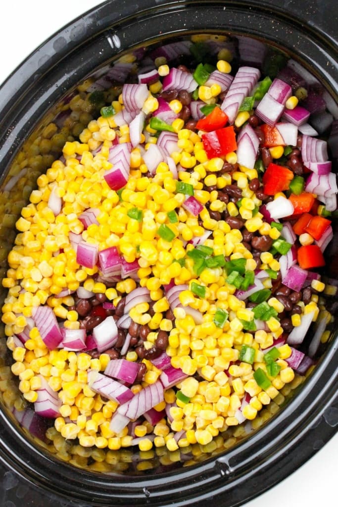 corn, onion, and black beans in a crockpot insert