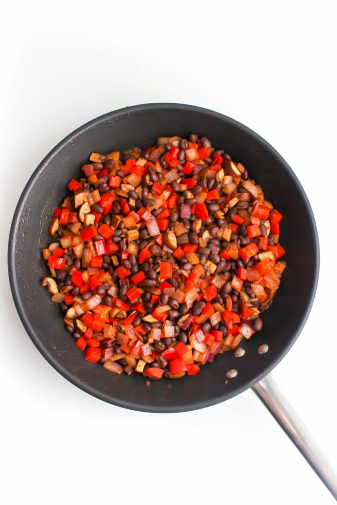 black beans, mushrooms, red onion, and bell peppers in a skillet