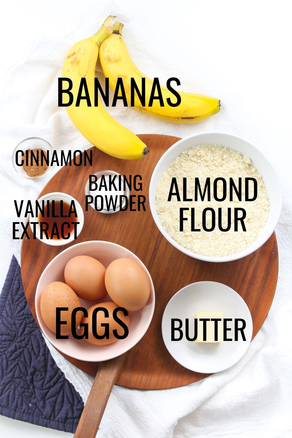 bananas, eggs, almond flour, and butter on a wooden platter