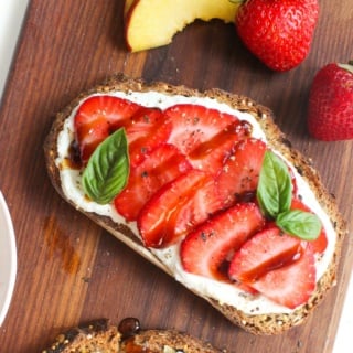 strawberry balsamic breakfast toast on a wooden cutting board