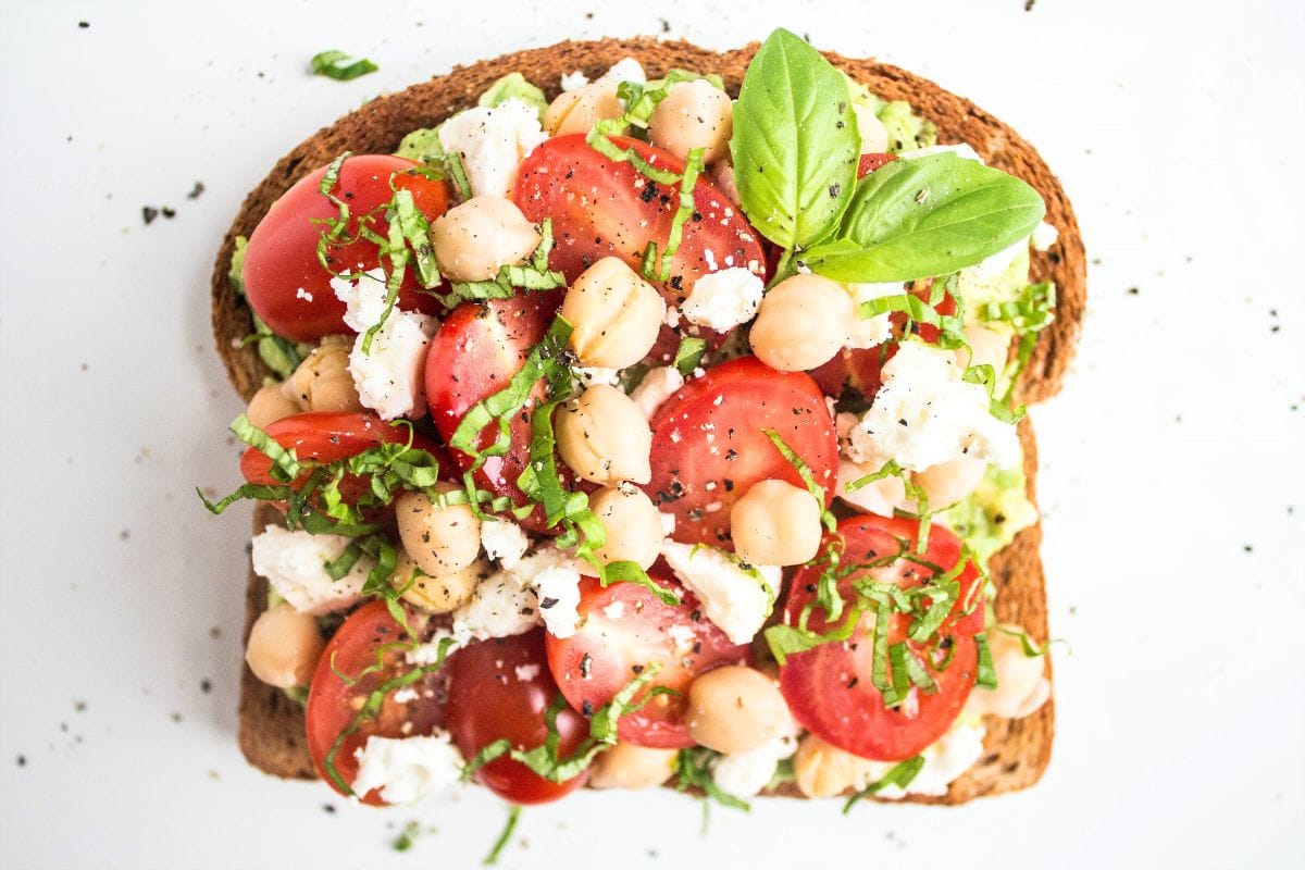 Mediterranean avocado toast with feta, chickpeas, and tomatoes