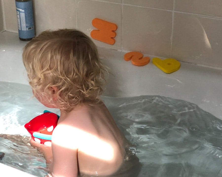 kid in bath with curls